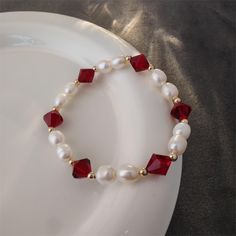 Pearls are known for their roundness, fullness and warm color, adding a touch of gentleness and nobility to the wearer. Red crystals are carefully cut to create square facets that sparkle in the sunlight or light. Red crystals not only symbolize passion and vitality, but also happiness and good fortune, bringing positive energy to the wearer. Red crystal bead measure approx. 8mm big, and freshwater pearls measure approx. 6mm big. Each natural freshwater pearl is unique, their size and shape migh Elegant Red Beaded Bracelets For Valentine's Day, Elegant Red Crystal Bracelet As Gift, Elegant Red Beaded Bangle Bracelet, Elegant Red Crystal Bracelet For Valentine's Day, Elegant Red Crystal Bracelet, Elegant Handmade Red Crystal Bracelet, Handmade Elegant Red Crystal Bracelet, Elegant Red Round Crystal Bracelet, Elegant Red Carnelian Beaded Bracelets