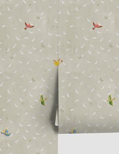 the wall paper has birds on it and is next to a roll of toilet paper