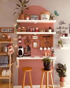 two wooden stools sitting in front of a pink wall with coffee signs on it