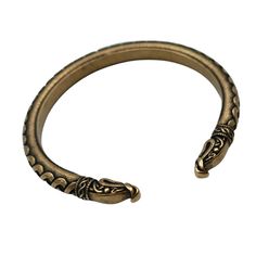 an antique brass bracelet with two snakes on it