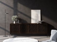 a living room scene with focus on the sideboard and floor lamp in the foreground