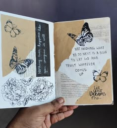 a hand holding an open book with butterflies on it and the words, not against light to do next is such to let go find trust trust just whatever comes up