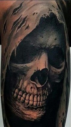 a man with a skull tattoo on his arm