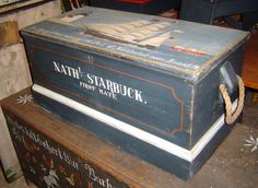 an old trunk sitting on top of a wooden table