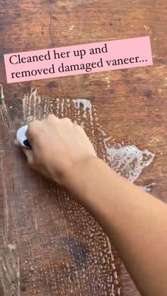 a person using a marker to remove damaged vaner from a table top with text on it