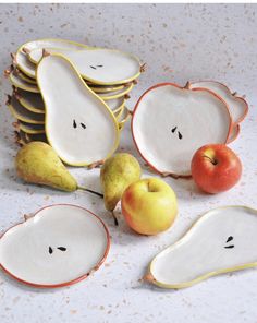 apples, pears and oranges are arranged in the shape of fruit plates with faces drawn on them