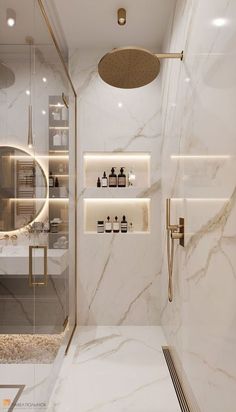 a bathroom with marble walls and flooring is shown in this image, there are shelves on either side of the shower