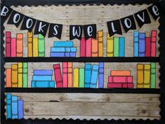 some books are stacked on top of each other in front of a sign that says books we love