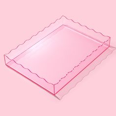 a pink plastic tray with scalloped edges on a pink background, it is empty