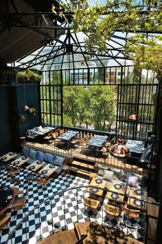 an outdoor dining area with black and white checkered flooring