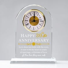 a glass clock with the words happy 30th anniversary written in gold and white on it