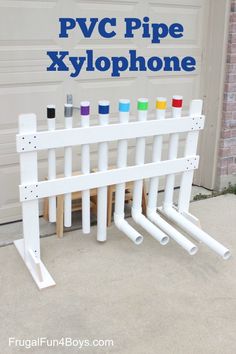 a group of white pipes sitting next to each other on top of a cement floor