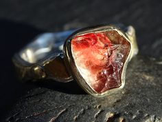 Handmade raw gemstone ring with a genuine Oregon sunstone crystal, set on a 14k gold and silver ring band. Organic and unique engagement ring, and perfect to be worn every day. Also a gorgeous gift for your anniversary, a beloved person or just to keep for yourself. > genuine uncut Oregon sunstone with a red and champagne color > 14k gold and sterling silver ring band > fits a size 8 1/4 but can be slightly upsized. This gemstone is a AA-quality, genuine Oregon sunstone, 3.12 carats in weight. I Silver Sunstone Jewelry With Gemstone, Raw Stone Ring For Anniversary, Unique Raw Stone Ring Jewelry, Unique Raw Stone Jewelry Ring, Unique Raw Stone Ring, Gold Jewelry With Raw Stone For Promise Ring, Anniversary Raw Stone Ring Jewelry, Healing Gemstone Nugget Jewelry, Healing Nugget Gemstone Jewelry