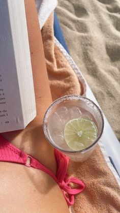 a book and a drink on the beach