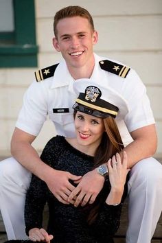 a man and woman in sailor outfits posing for a photo on the deck of a ship