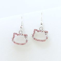 hello kitty earrings with pink swarongs and silver earwires on white background