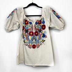 Mexican Embroidered Floral Blouse. Size M. Cream With Colorful Embroidered Flowers. Flat Measurement Of Length Is 23” And Armpit To Armpit Is 19”. Nwot (E723149) Spring Short Sleeve Blouse With Resham Embroidery, Spring Festival Blouse With Resham Embroidery, Spring Festive Embroidered Short Sleeve Top, Summer Festive Blouse With Floral Embroidery, Festive Spring Embroidered Top With Short Sleeves, Festive Floral Embroidered Summer Blouse, Folk Style Floral Embroidered Top For Festive Occasions, Festive Embroidered Short Sleeve Top For Spring, Festive Folk Style Embroidered Top With Floral Embroidery