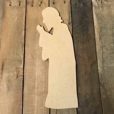 a wooden cutout of a person holding a cell phone