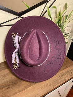 Purple colored wide brim felt hat with custom band and hand burned design. One size fits most. 59cm diameter with an adjustable inner-headband. *colors may vary slightly due to lighting. Wide Brim Felt Hat, Skull And Flowers, Hand Burn, Bull Skull, Bella Vista, Bull Skulls, Felt Hat, Wide Brimmed, Purple Color