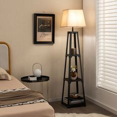 a bed room with a neatly made bed and a night stand next to the window