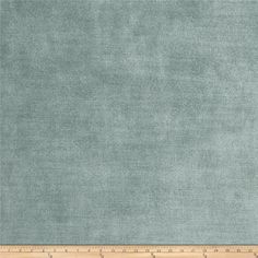 a ruler is next to an area rug that has been made with light blue fabric