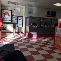 a red and white checkered floor in a laundry room with washer dryers