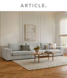 a living room with white walls and wood flooring is featured in the article article