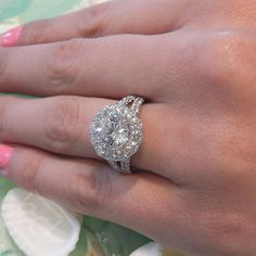 a woman's hand with a diamond ring on it