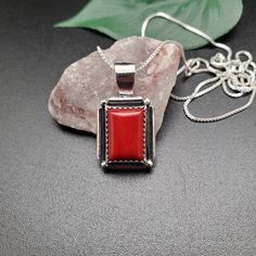 Visit our on-line shop at: Etsy.com/shop/AlbuquerqueDesigns *sterling silver necklace pendant *rectangle shape pendant with silver box chain necklace 18 inches long *southwestern jewelry *red coral *calibrated pre-cut stones in millimeter and shape of stone: 14x10nn rectangle shape *back of jewelry items are all covered / do not show the back of stones *all jewelry items are made to ship, slight variations in stones will occur comparing to pictures. *size of a penny is 19mm or a dime is 18mm in Silver Rectangular Necklace With Polished Finish, Square Sterling Silver Jewelry With Polished Finish, Gift Necklace With Polished Finish And Rectangular Pendant, Classic Necklace With Rectangular Pendant For Gifts, Rectangular Pendant Necklace With Box Chain, Red Rectangular Stone Jewelry For Gifts, Gift Box Chain Necklace With Rectangular Pendant, Red Rectangular Stone Jewelry Gift, Rectangular Pendant Box Chain Necklace For Gifts