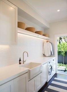 a washer and dryer in a white laundry room