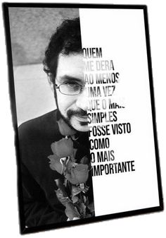 a black and white photo of a man wearing glasses with flowers in front of him