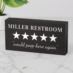 a wooden sign that says miller restroom with five stars on it and the words would pop here again