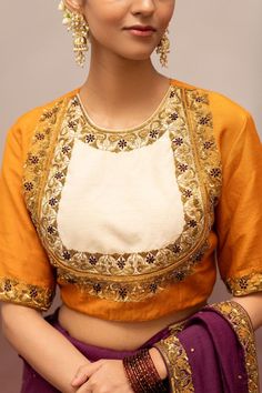 Mustard and ivory blouse with floral, sequins embroidery.
Components: 1
Pattern: Embroidery
Type Of Work: Floral, Sequins
Neckline: Round Neck
Sleeve Type: Half Sleeves
Fabric: Munga Silk
Color: Yellow
Other Details: 
Model height: 5ft 7inches, wearing size S
Note: The saree and jewellery worn by the model is not for sale
Occasion: Puja - Aza Fashions Semi-stitched Blouse With Intricate Embroidery For Navratri, Traditional Embroidered Top With Traditional Drape For Wedding, Traditional Embroidered Top With Drape For Wedding, Designer Eid Blouse In Chinon, Designer Chinon Blouse For Eid, White Designer Tops For Festivals, Designer Cotton Silk Blouse With Floral Embroidery, Silk Blouse With Floral Embroidery For Navratri, Designer Blouse With Intricate Embroidery For Navratri