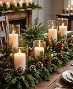 a table with candles and pine cones on it