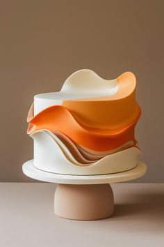 an orange and white cake sitting on top of a table