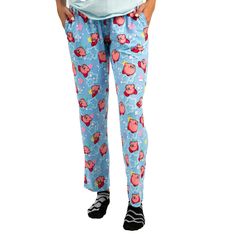 Elevate your relaxation game with this officially licensed Kirby Adult Juniors Sleepwear Set. This set includes a comfortable light blue short sleeve tee shirt crafted from a blend of 60% cotton and 40% polyester for a soft and breathable feel. The tee shirt showcases everyone's favorite video game hero, Kirby, front and center, adding a pop of fun to your loungewear. Accompanying the tee shirt are light blue sleep pants that feature an all-over repeat print of Kirby surrounded by playful stars. Casual Relaxed Fit Bedtime Pants, Casual Relaxed Fit Pants For Bedtime, Playful Relaxed Fit Bottoms For Pajama Party, Casual Light Blue Sleepwear For Loungewear, Light Blue Casual Sleepwear For Sleepover, Cute Cotton Lounging Pants, Casual Cotton Bottoms With Cartoon Print, Light Blue Casual Sleepwear For Loungewear, Casual Light Blue Sleepwear For Sleepovers