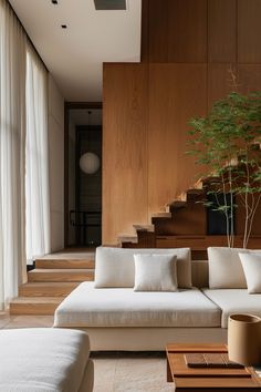 a living room filled with furniture and a tree