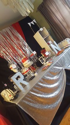 the table is covered with silver sequins and red, white, and black decorations