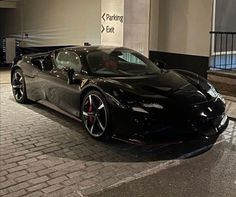 a black sports car parked in front of a building