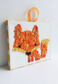 an orange and white bag with buttons on the front is decorated with a fox's head