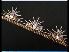 two gold bracelets with sunburst and crystal stones on the sides, one is yellow