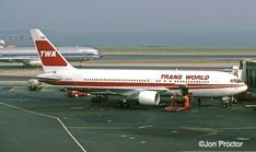 an airplane is parked on the tarmac near other planes