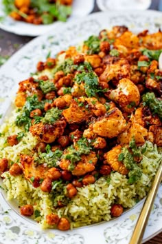 a white plate topped with rice and meat