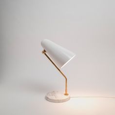 a white table lamp with a marble base