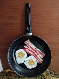 an iron skillet with eggs and bacon on it