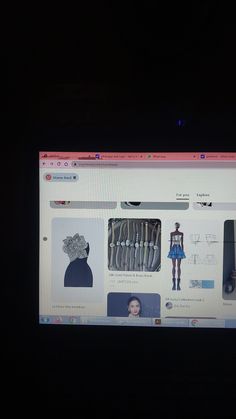 a computer screen with pictures on it in the dark, showing an image of women's clothing