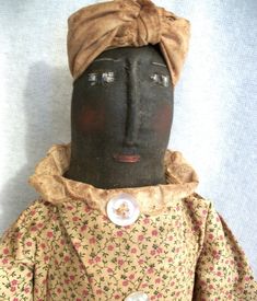 an old black doll with a turban on it's head