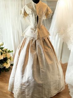 a dress on display in front of some white dresses