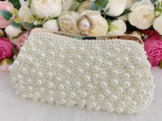 This elegant bridal clutch features gold trim, attachable chain and large enough for your phone. Complete your list of must-have wedding accessories with the ultimate bridal accessory to finish off your look and storing your wedding day essentials. Details： Inside Material: Satin Size: 9.8*1.6*5.1inch/25*4*13cm Come with a removable short chain（37cm） and a long chain（116cm) and a pearl chain that can be used as shoulder bag or crossbody bag or as clutch. Request a cancellation within 24 hours of Gold Pearl Evening Bag For Events, Gold Beaded Bridal Accessories For Formal Occasions, Gold Clutch With Pearl Embroidery, Gold Pearl Clutch With Pearl Embroidery, Formal Gold Clutch With Pearl Material, Cream Pearl Evening Bag For Wedding, Gold Pearl Bags For Formal Occasions, Gold Beaded Clutch For Wedding, Pearl White Wedding Clutch With Pearl Handle