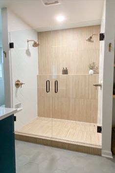 a walk in shower sitting inside of a bathroom